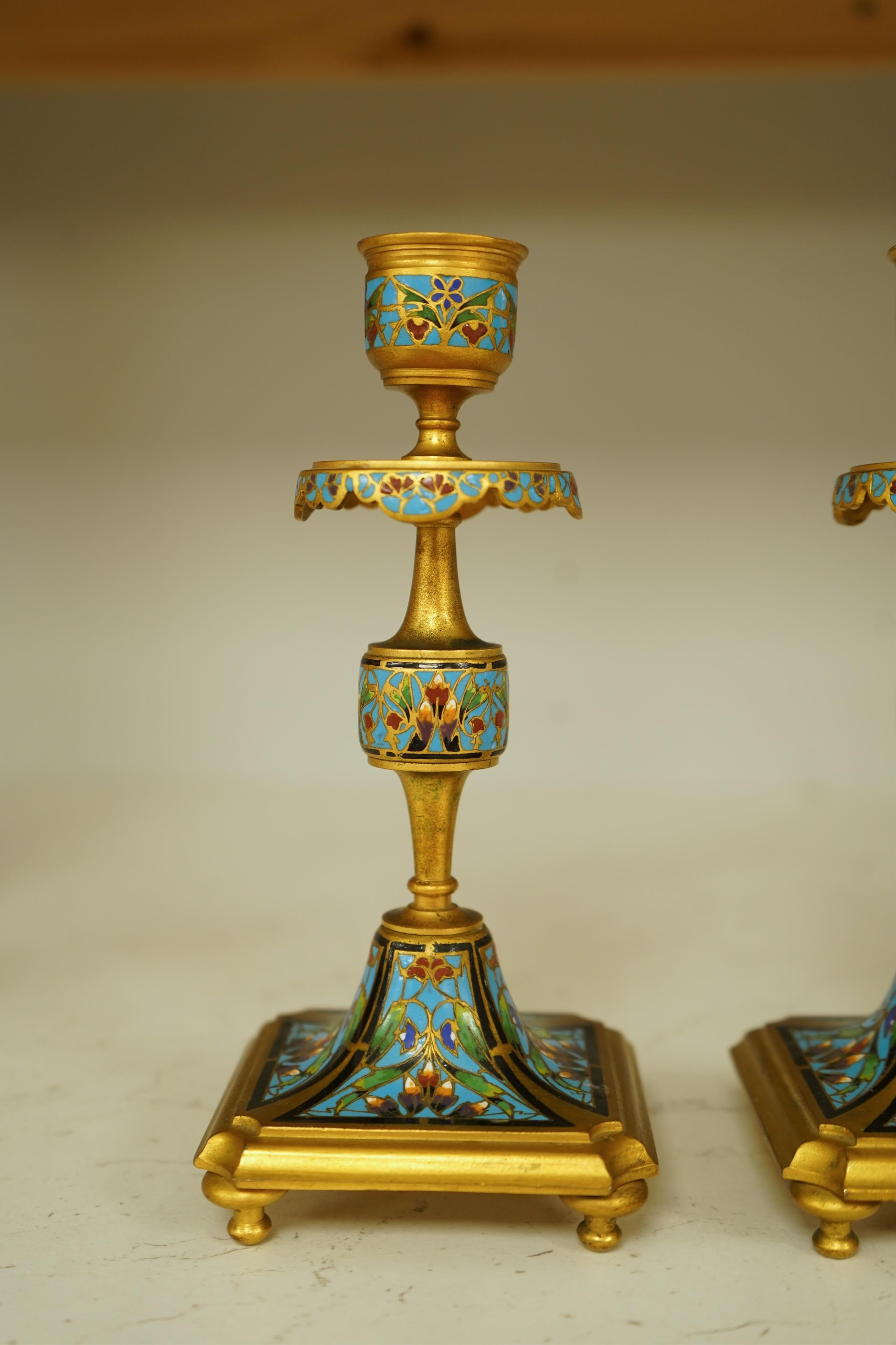 A pair of late 19th century French champleve enamel and ormolu candlesticks, 17cm